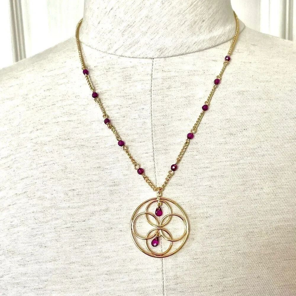Avon gold tone circle necklace with purple rhinestones